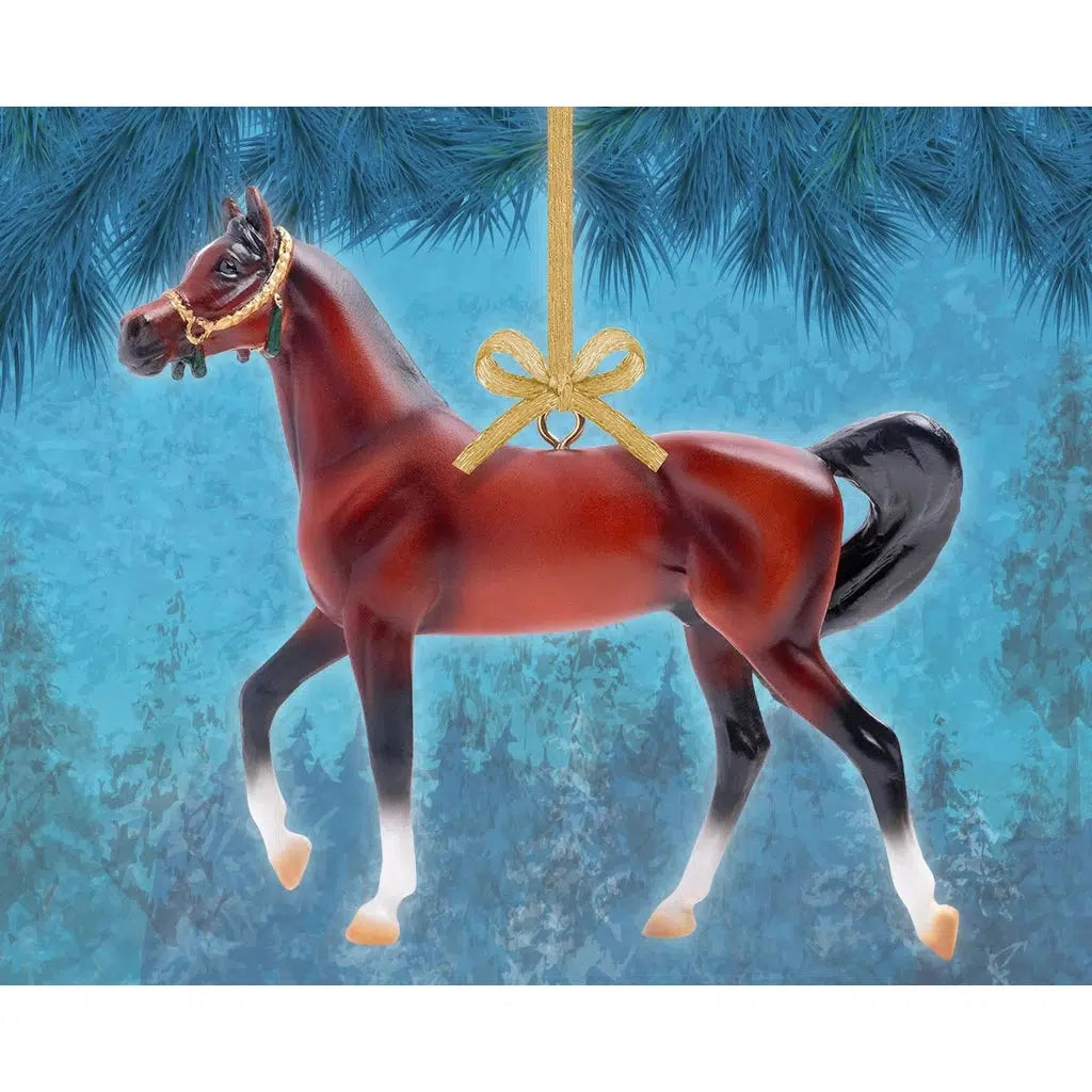Image of the Arabian horse ornament up against a blue Christmasy background. Ornament described on next image.