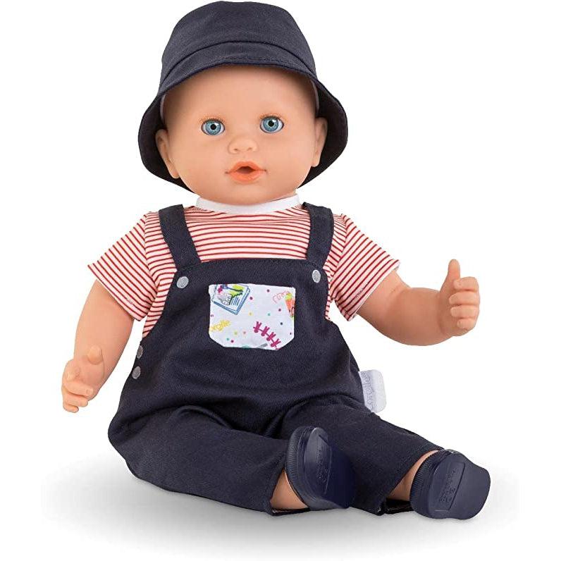 baby doll with a black bucket hat and overalls over a red and white striped shirt