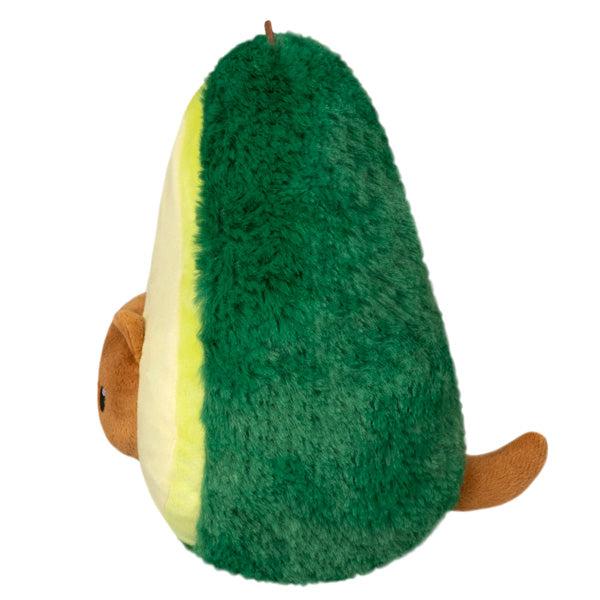 Side view of the plush. Shows that there is a cat tail coming out of the back of the avocado.
