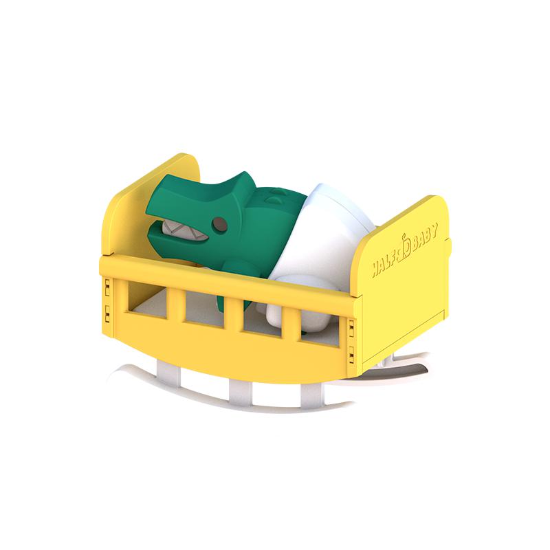 Image of the yellow rocking crib that is included in the toy.