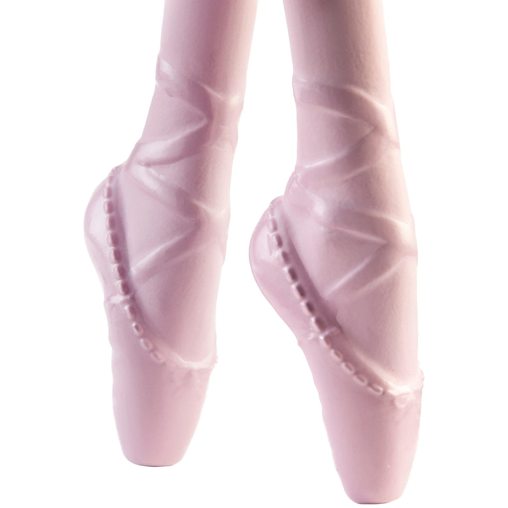 Up close view of the feet. The feet are shaped so that they are fully extended in ballerina stance. The ballerina slippers are made into the foot with a back-and-forth lacing design.