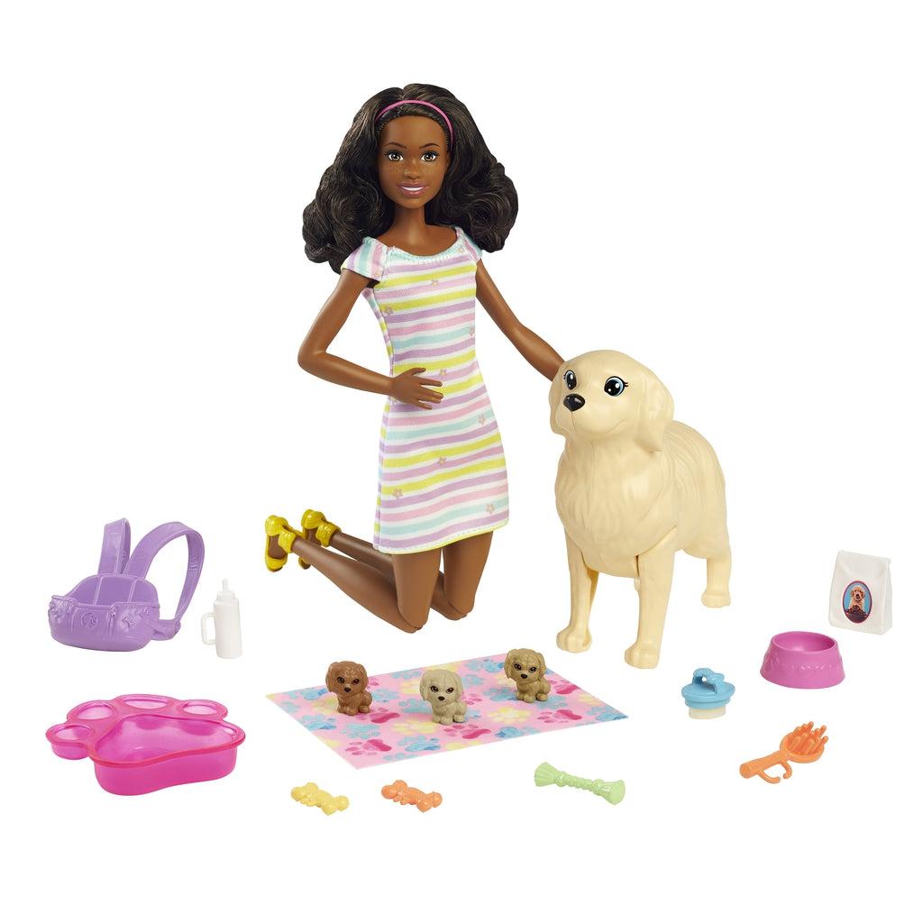 Image of all the included pieces outside of the packaging. The set includes a Christie doll, a momma dog, three newborn pups, a towel, a puppy carrying basket, treats, and food.