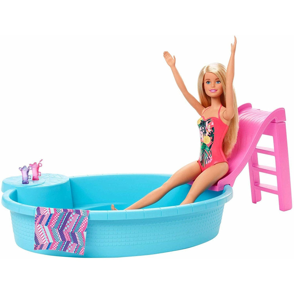 Image of Barbie and her pool outside of the packaging. Barbie is wearing a pink bathing suit. The set also includes a slide, a towel, and two drinks.