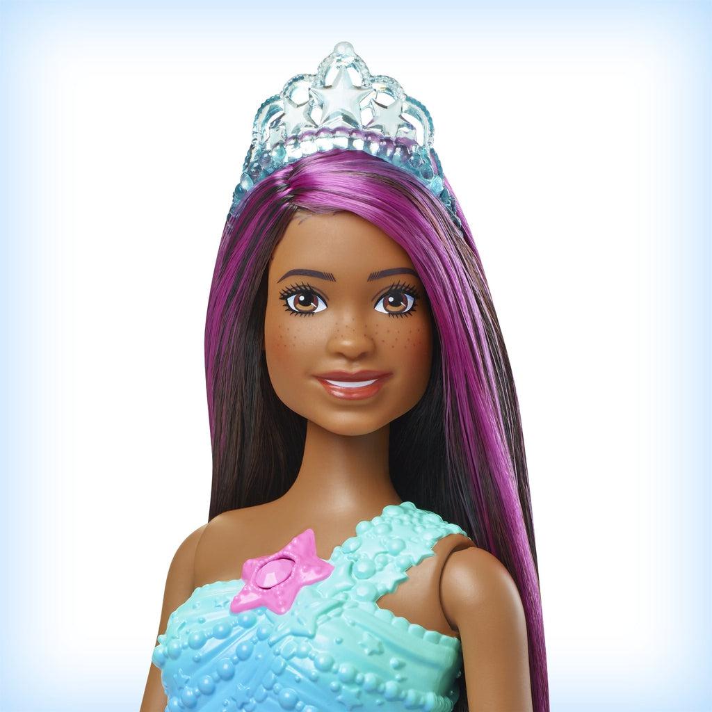 Up close shot of Barbie's face. She has long black and pink hair. She comes with a clear tiara and this Barbie has freckles.