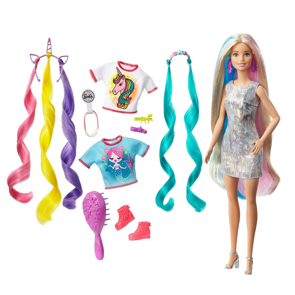Image of the included pieces outside of the packaging. The set includes Barbie with special sparkly blue and pink hair in a silver dress, two t-shirts (one with a mermaid on it and one with a unicorn on it) a mermaid headband, a hairbrush, and an extra pair of shoes.
