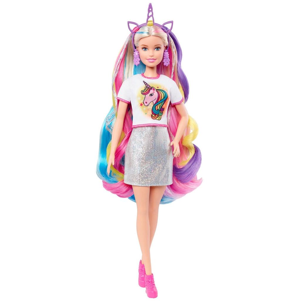Shows Barbie in her unicorn outfit. She is wearing the shirt and the headband.