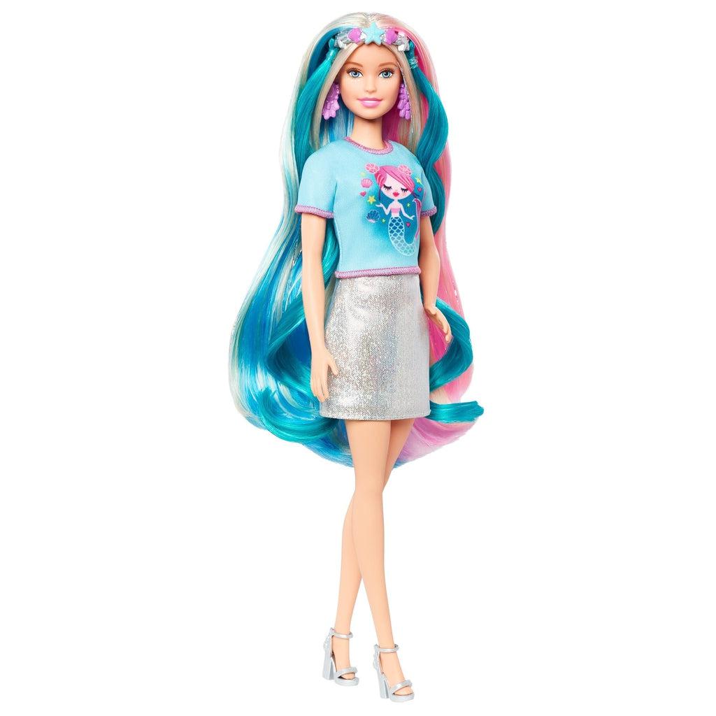 Shows Barbie in her mermaid outfit. She is wearing the headband and the t-shirt.