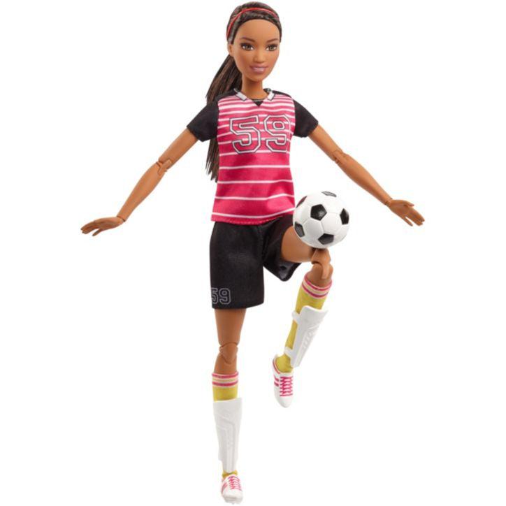 Image of the Barbie outside of the packaging. She is wearing a black and red soccer uniform with 59 as her number. She has cleats and long yellow socks. She comes with a soccer ball and two shin guards.