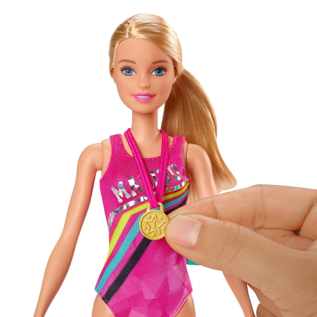 Shows Barbie winning a gold medal for her swimming.