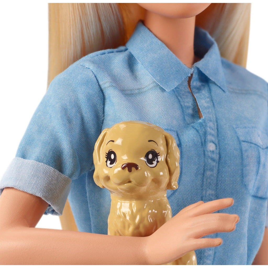 Up close shot of Barbie's dog. The dog is tan and small enough to carry in Barbie's arms.