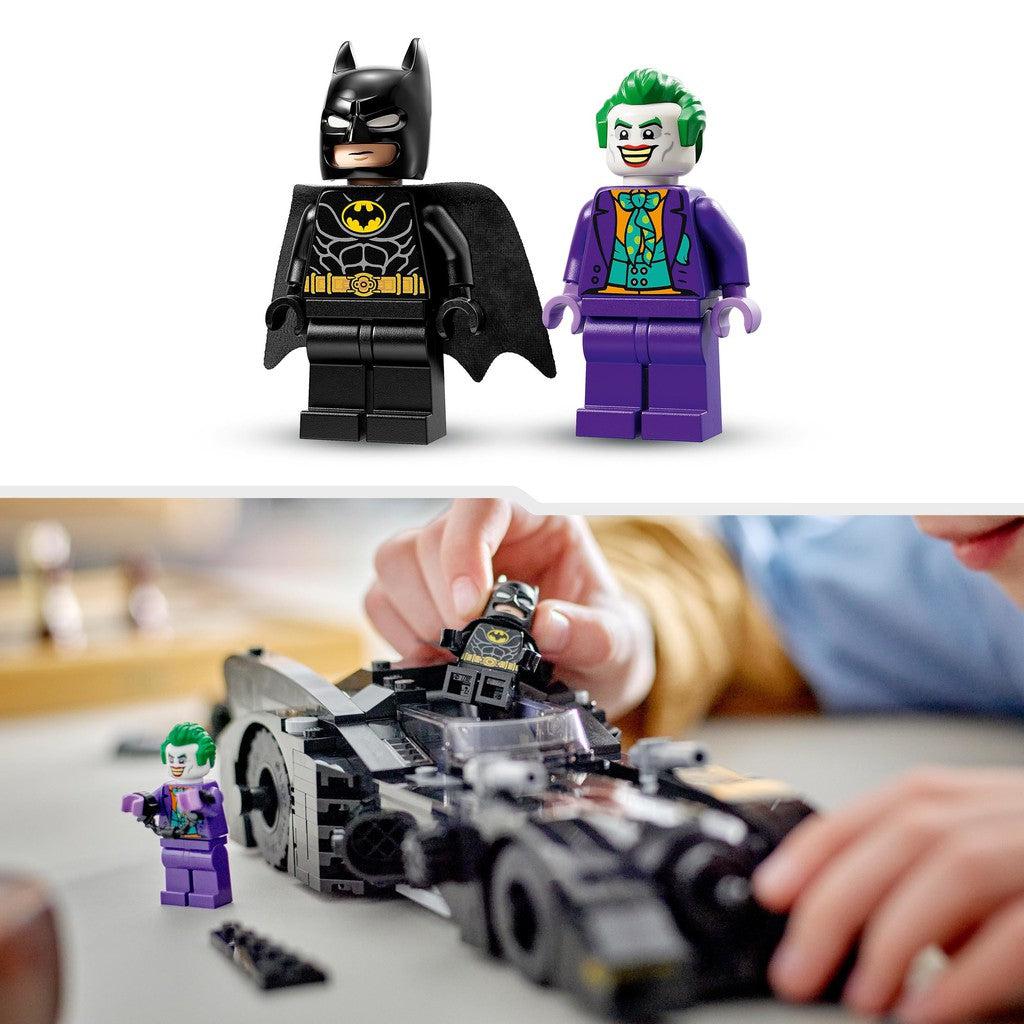 a boy is putting batman into the cockpit of the Batmobile ready to chase Joker who is wearing broken handcuffs
