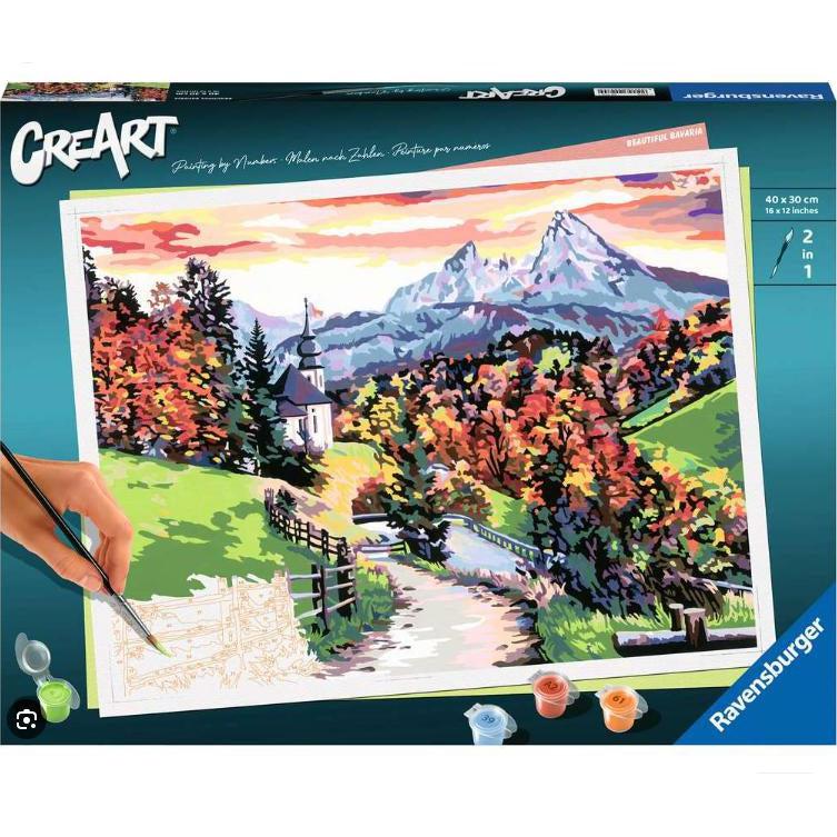 the beautiful bavaria paint by numbers box shows a 2 in 1 paint brush painting a stunning landscape with a winding dirt road fenced in. autumn orage is on the trees with a building in the background framed in two stunning mountains basking in the sunset. 