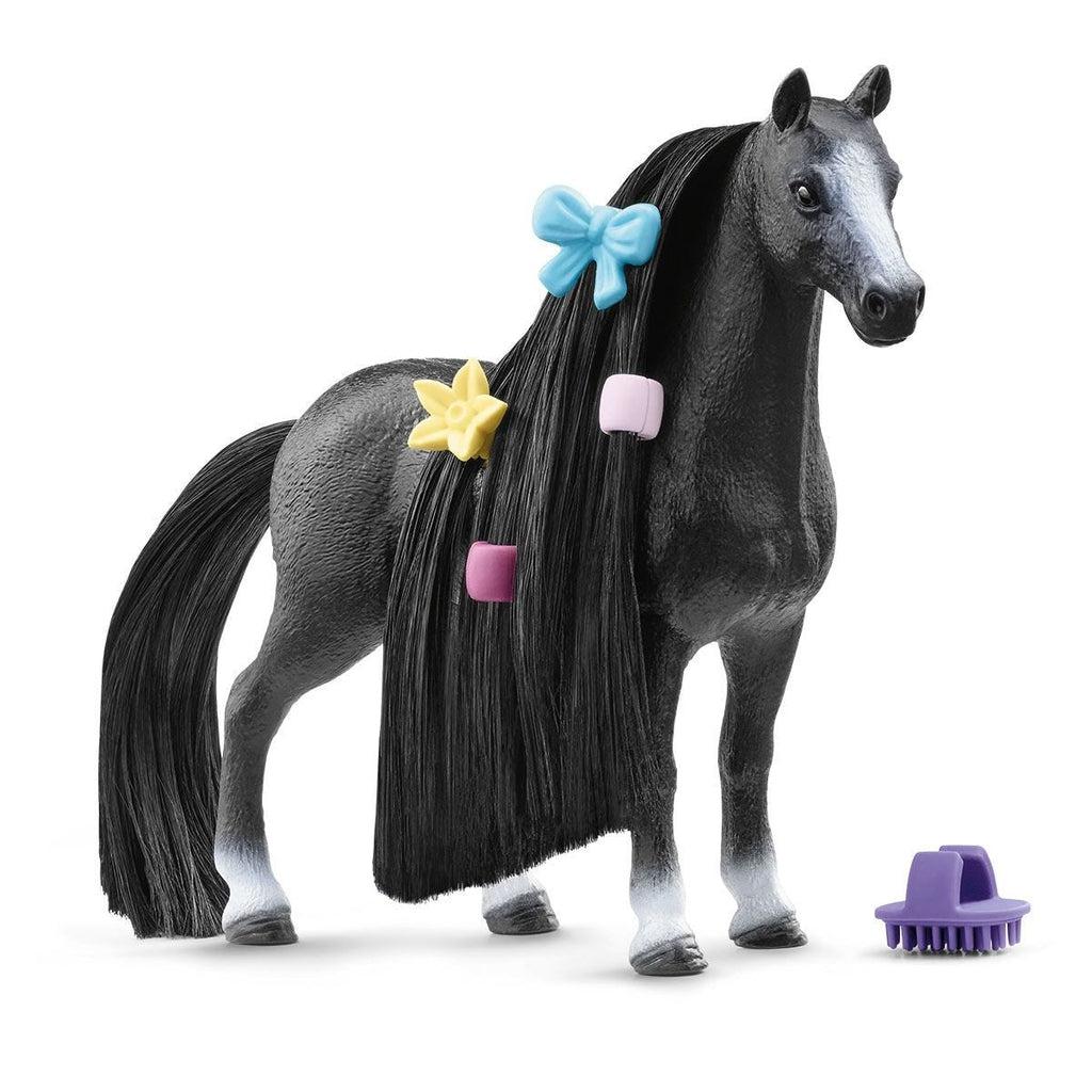 Image of the figurine outside of the packaging. It is a black horse with long black hair that can be braided and beaded.