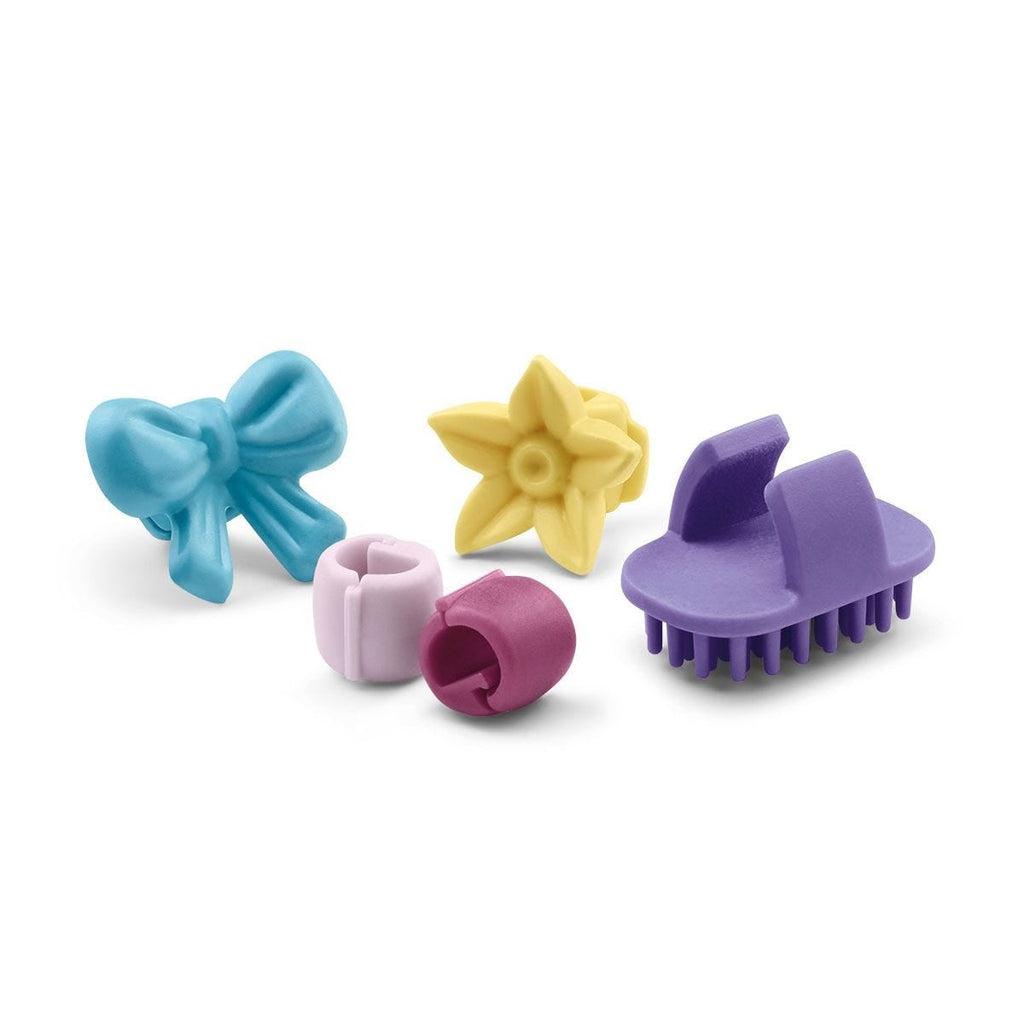 Image of the included hair accessories. It comes with different colored beads and a small brush.