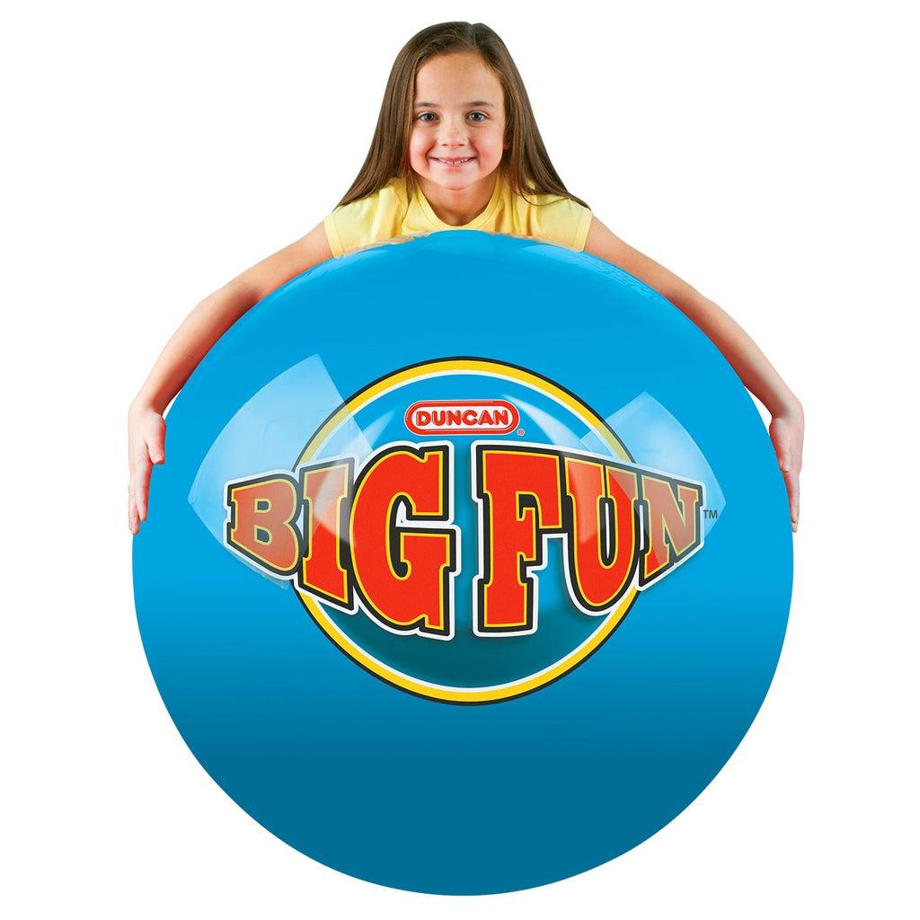 Young girl wraps her arms over the top of the ball | Ball is bright blue with "BIG FUN" in large red letters.