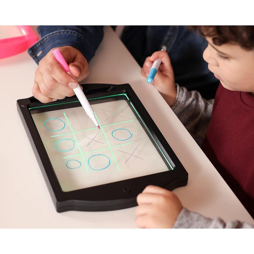 this image shows a child playing tic-tac-toe on a board. 