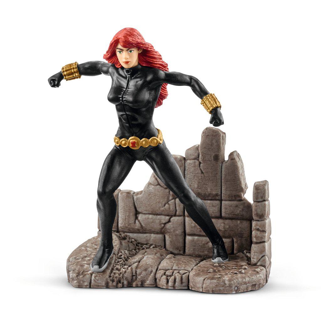 Image of the figure outside of the packaging. She is wearing her classic black suit with gold accents. She has long red hair and is standing on a corner of stone rubble.