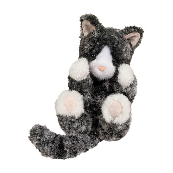 this cat is posing with its white mitten feet in the air showing off its toe beans! cute and soft black fur is the body for this adorable creature. 