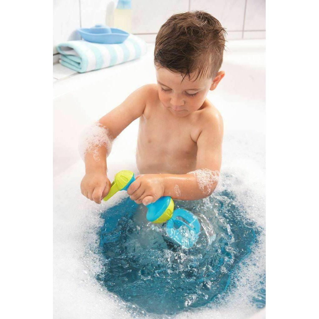 Scene of a little boy using the whisk to make bubbles in his bubble bath.