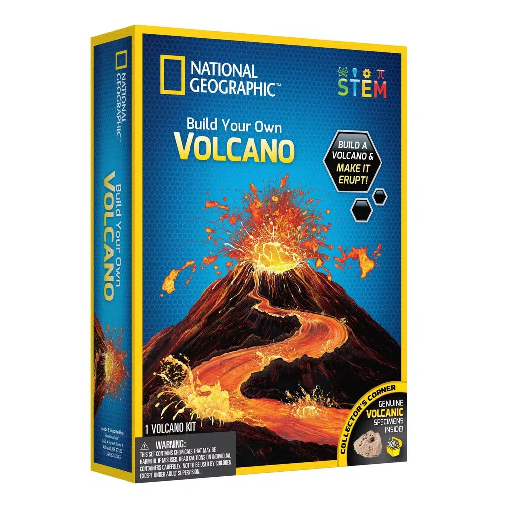 this image shows the box for the build your own volcano. text reads "Build a volcano and make it erupt!' and a genuine volcanic specimen inside. the image shows a volcano giving a mighty eruption with lava flowing down the side like a river. 