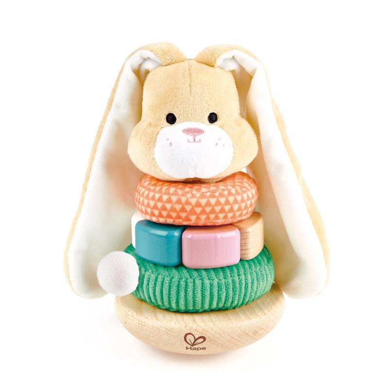 Image of the Bunny Stacker toy. It is a soft tan bunny with his belly made from different fabrics and wooden blocks. The bottom is rounded so it can wobble around if pushed.