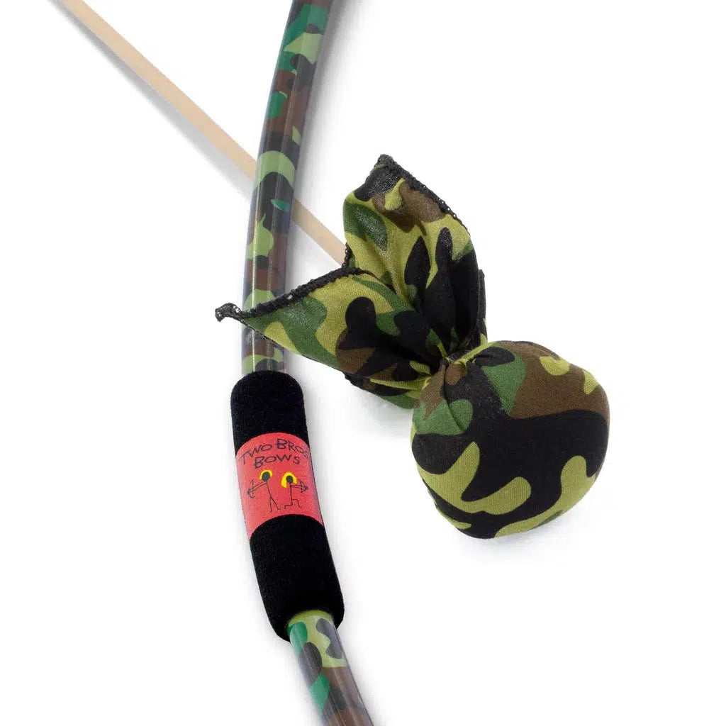 a bow with a camo pattern and a foam grip next to an arrow with a large soft rounded camo print tip