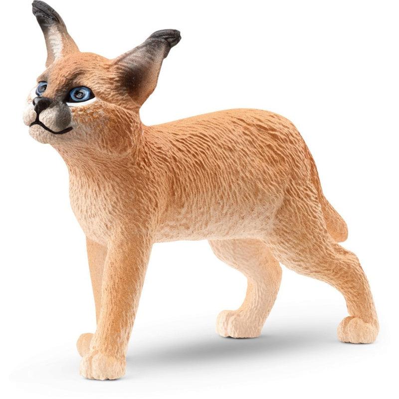 Image of the Caracal Cub figurine. It is a dark sandstone color with black tips to its nose and ears.