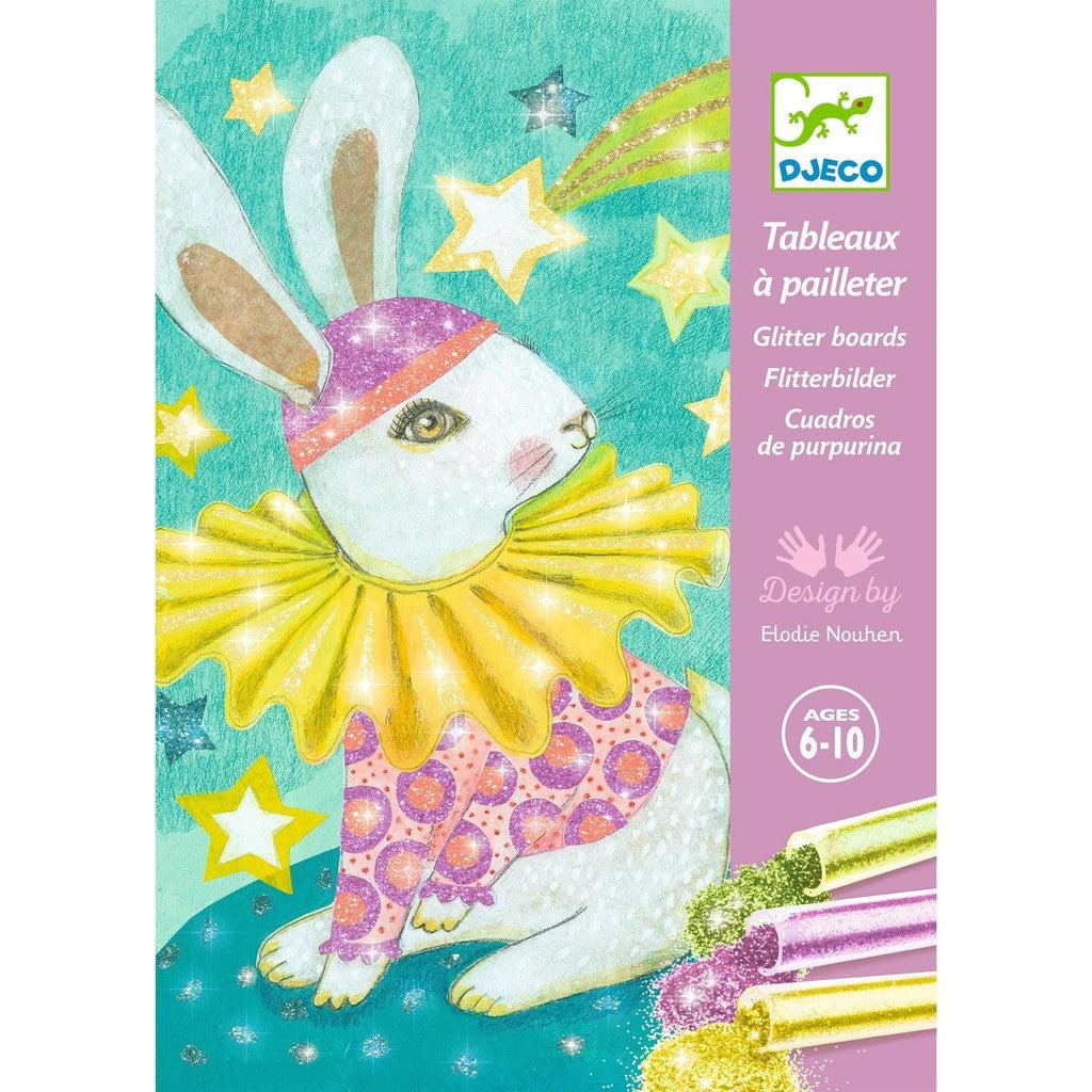 the packaging shows 3 tubes of glitter spilling out next to one of the pictures included of a rabbit in a shirt, hat, and wide frilled collar all colored with glitter