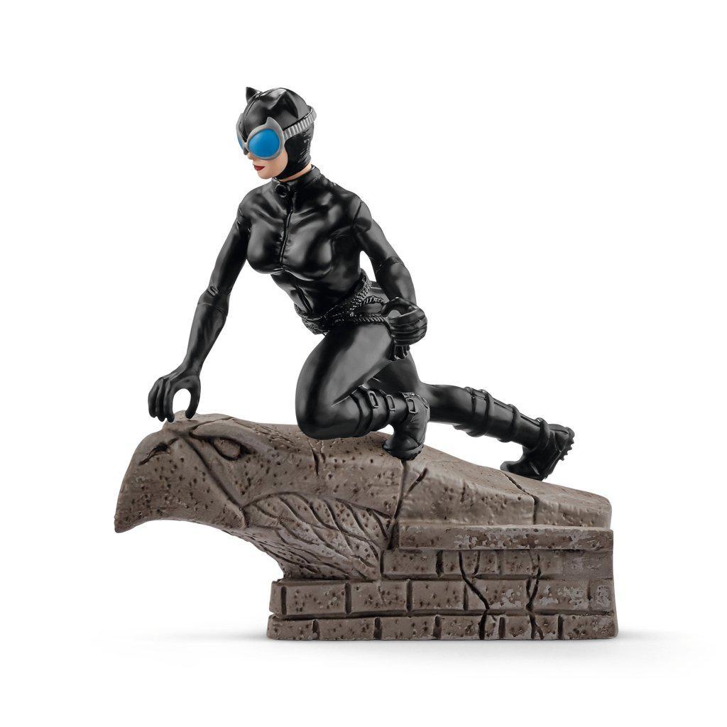 Image of the figurine outside of the packaging. It is catwoman in her iconic black leather suit wearing goggles and crouching on a stone bird statue.