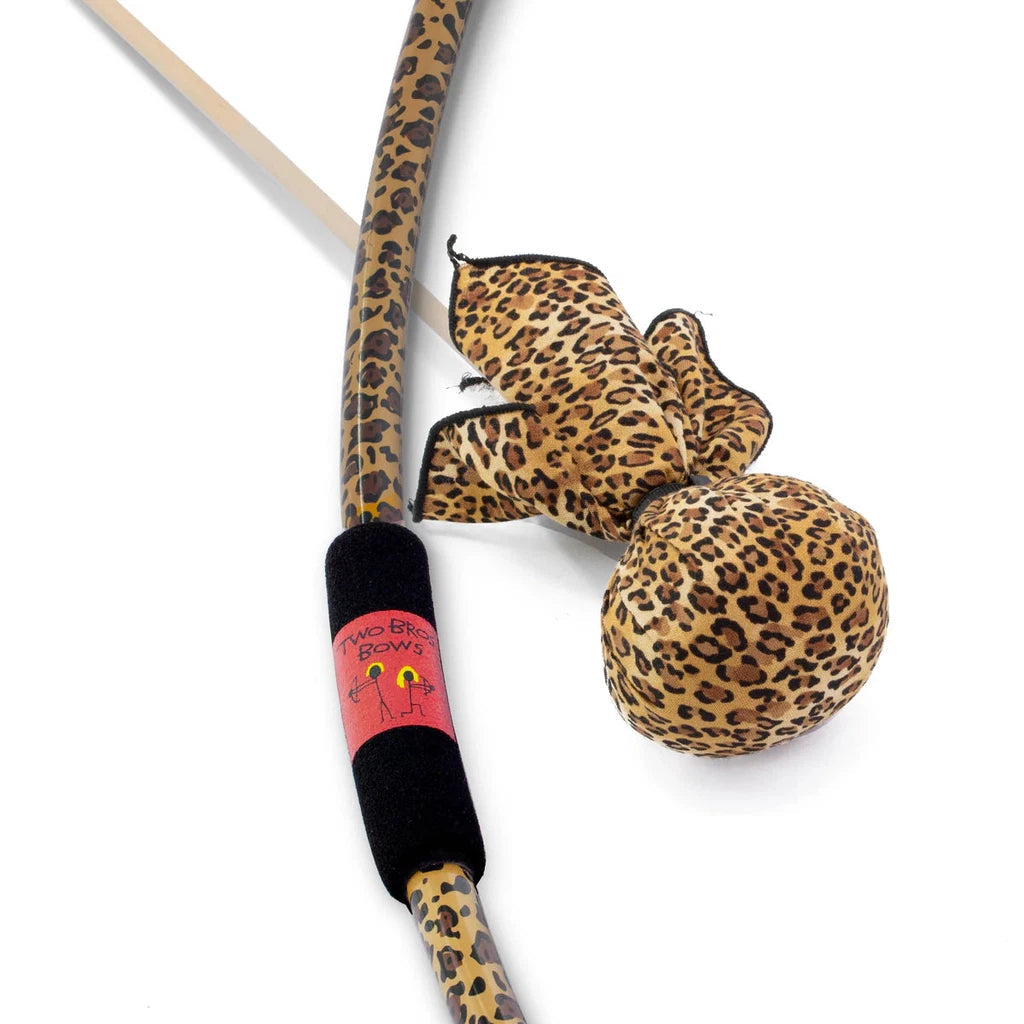 a bow with a cheetah pattern and a foam grip next to an arrow with a large soft rounded cheetah print tip
