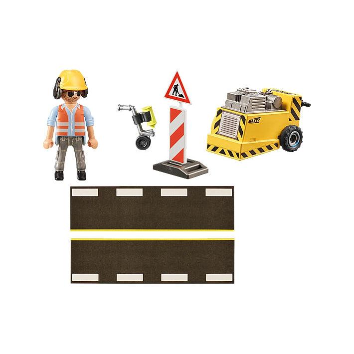 This image shows everything in the box a construction worker needs. the little guy with his helmet and earmuffs, a smile, paint on a roller, road and a working sign, finally an edge router. 