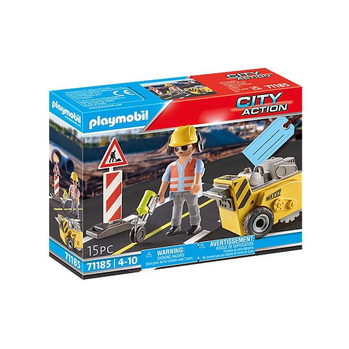 the playmobil construction worker. this picture shows the box the construction comes in, with an image of the little guy working on painting a yellow line on the road, with a construction sign by his side as he labors for long hours into the day with no escape!