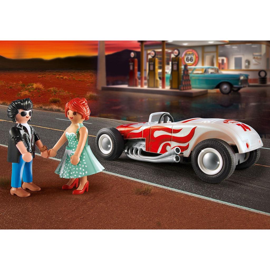 this image shows the boy and girl holding hands while the car is unoccupied on a road, the key is in the engine and the hot rod is slowly pulling away from the couple. 