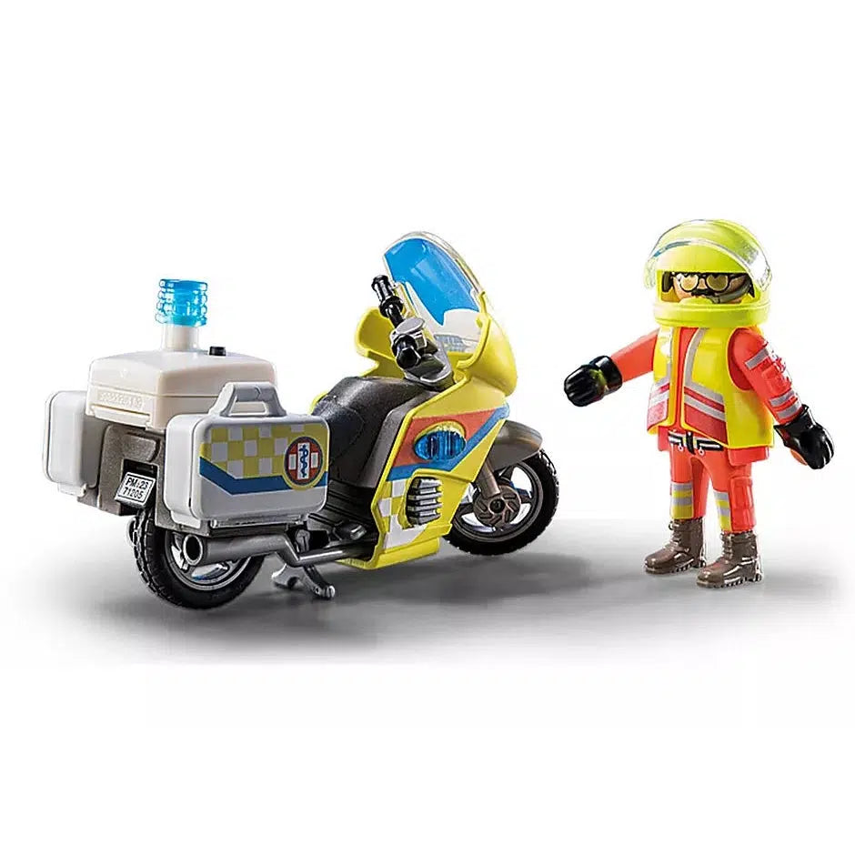 this picture shows the motorcyclist and the driver standing next to eachother, showing off the back of the cycle with its first said kit with the man wearing a helmet for safety. 