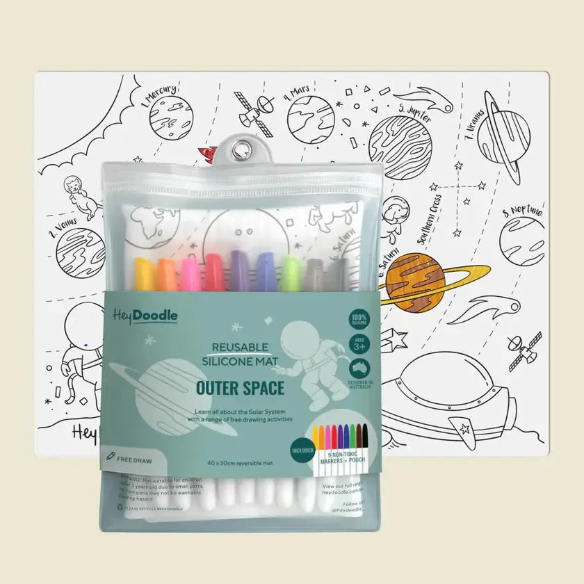 A reusable silicone coloring mat with an outer space theme is shown, packaged with a set of colored markers in a transparent pouch. Featuring drawing prompts, this mat encourages creativity and offers endless fun for kids.