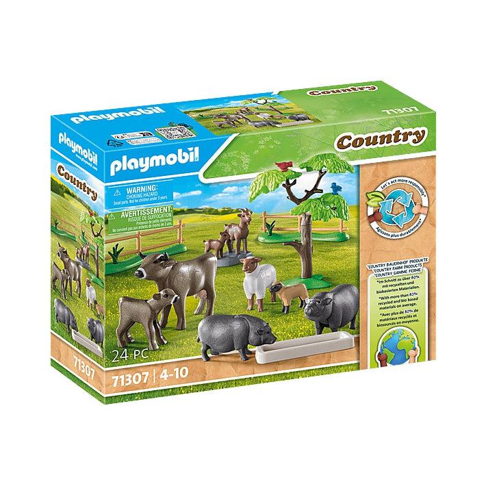 this animal set shows a pen with a plethora of animals. there are cows, pigs, goats, sheep. 