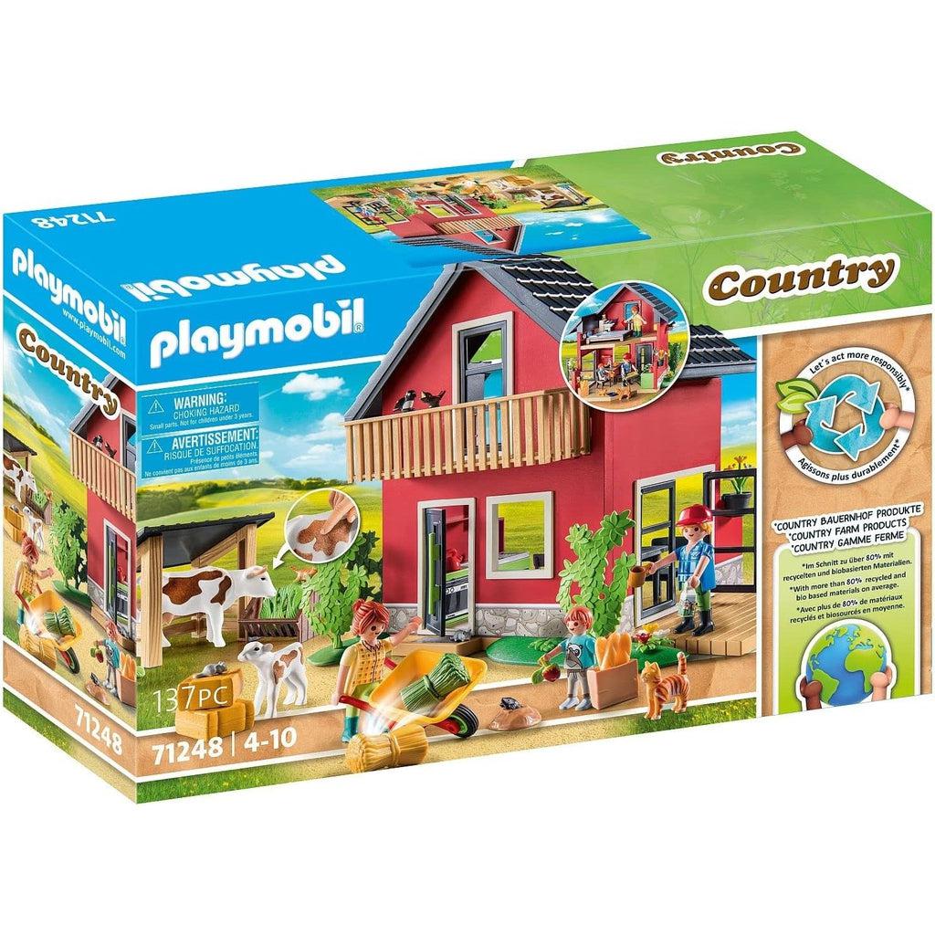 picture of the playmobil country farmhouse. the farm is two stories and has a happy family that lives in it and farm animals out front. 