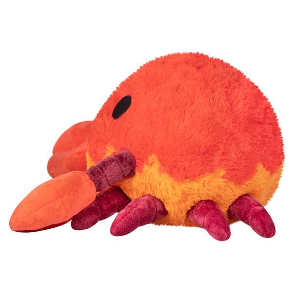 Side view of the plush. Shows that it has four legs on each side of its body.