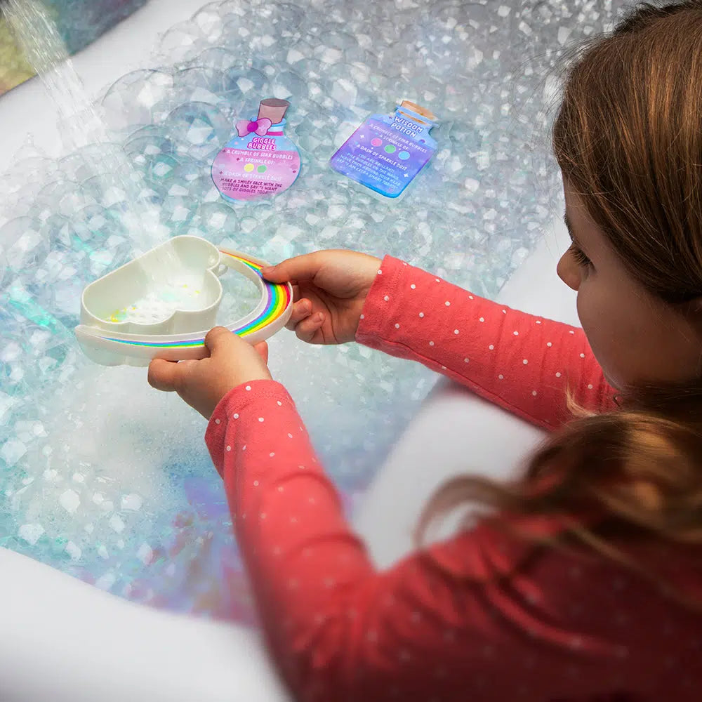 a girl is filling up a case with tater and the holes are sprinkling the water out to make bubbles. 