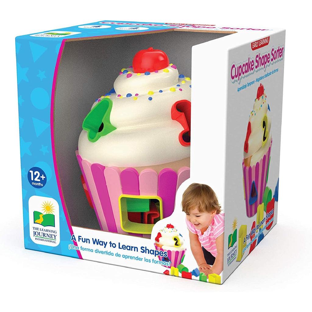 This image shows a shape sorter for infants and toddlers that is shaped like a cupcake