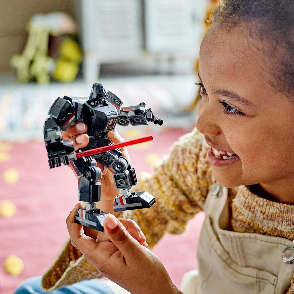 image shows a kid playing with the Darth Vader Mech