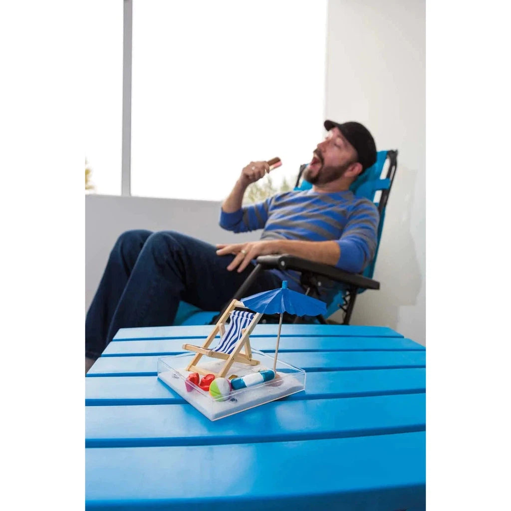 image shows a man relaxing on a beach chair next to the day at the beach zen garden beach