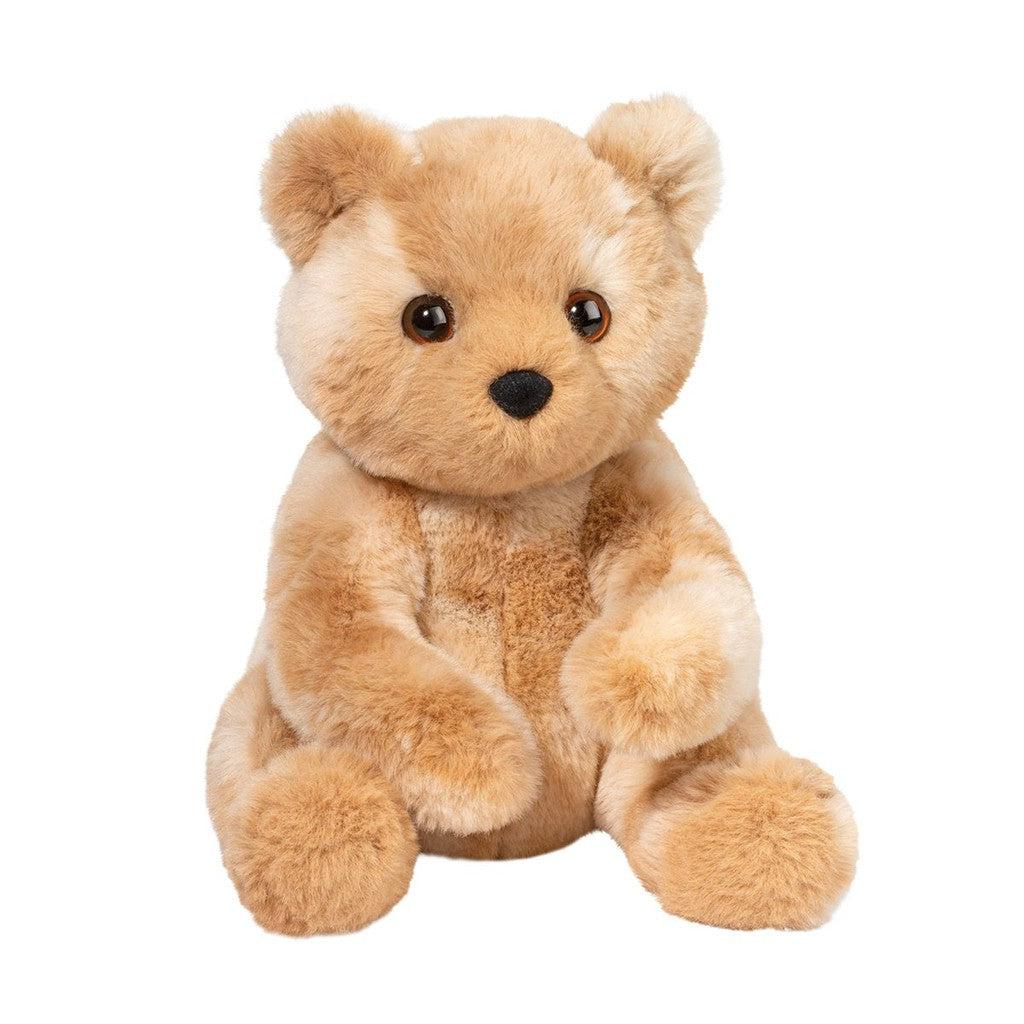 this image shows a plush tan bear with wide brown eyes and a black nose. the bear is fluffy and soft