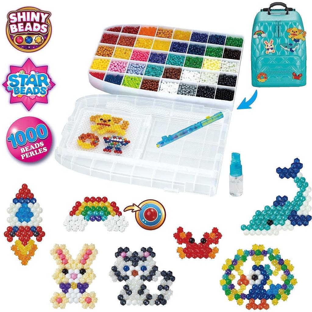 Image of all the included materials in the bag. It also has some pictures of possible aquabeads creations like a rocketship, a crab, and a raccoon.