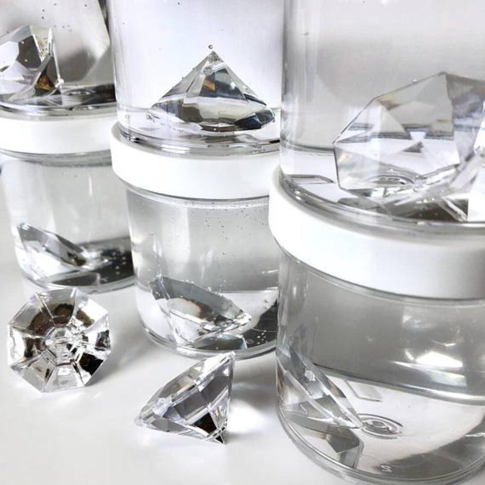 this image shows jars with a large diamond in it surrounded by clear slime