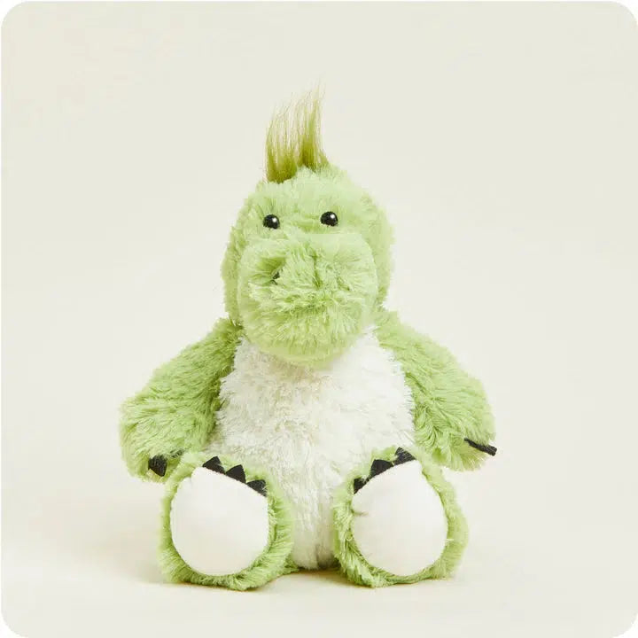 Image of the Dinosaur Warmies plush. It is a green dinosaur with a hair tuft on the top and a white belly. You can see that the dinosaur has black claws on their hands and feet.