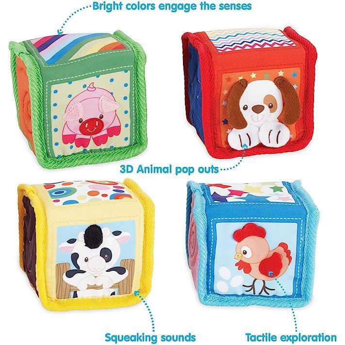 Image of the blocks outside of the packaging. Each one is a different color (green, yellow, red, and blue) with a different animal on it (pig, cow, chicken, and dog). Each block has different textures and sounds that entertain.