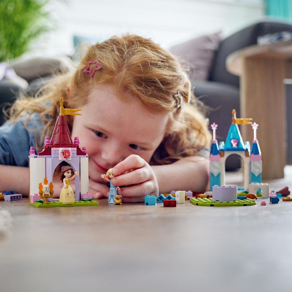 Scene of a little girl playing with some of her castle creations.