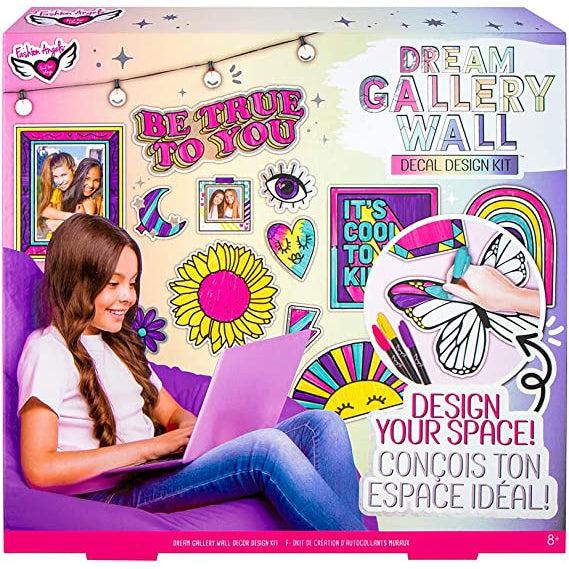 Image for the Dream Gallery Wall craft kit. On the front is a picture of a girl sitting in her room that is decorated by DIY stickers.