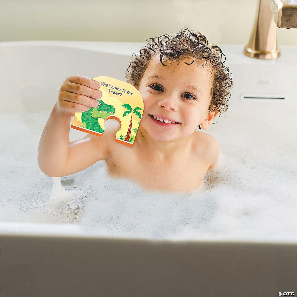 Scene of a little boy smiling and holding one of the puzzle pieces in the bath.